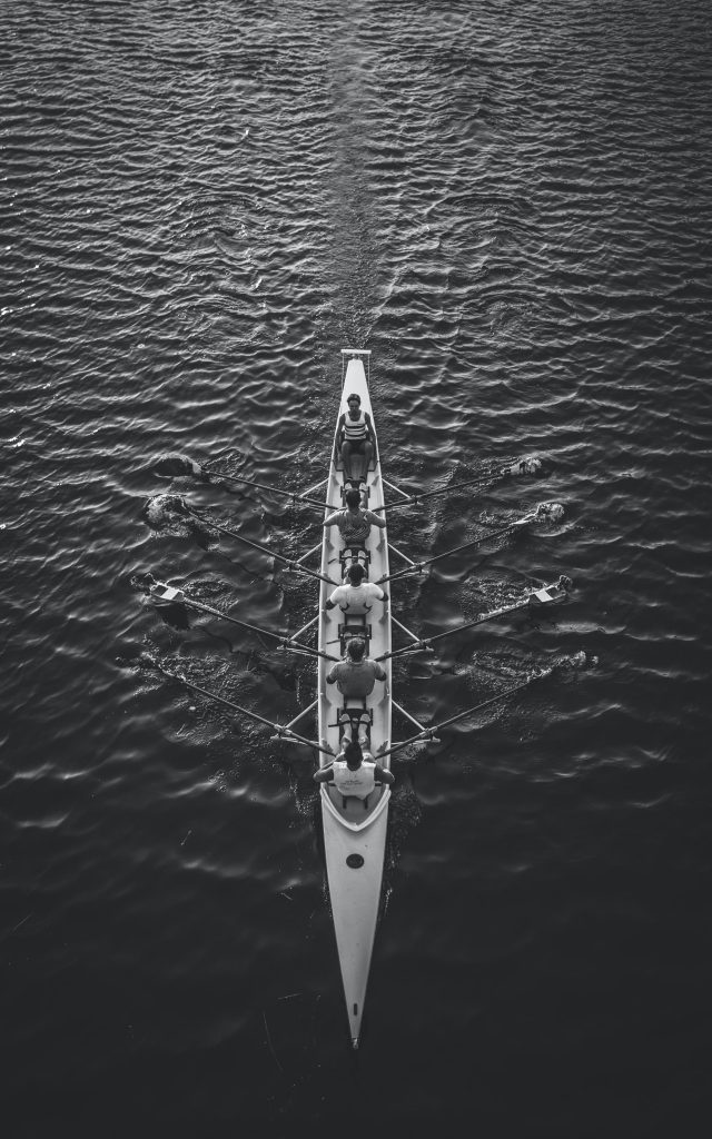 people riding boat on body of water